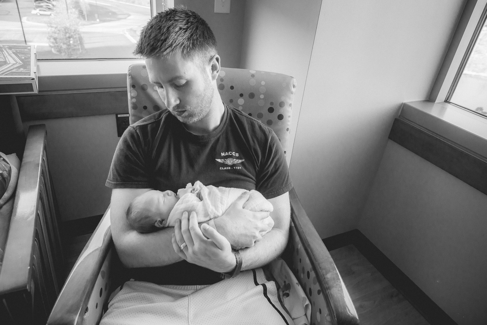 father holding newborn baby in the hospital