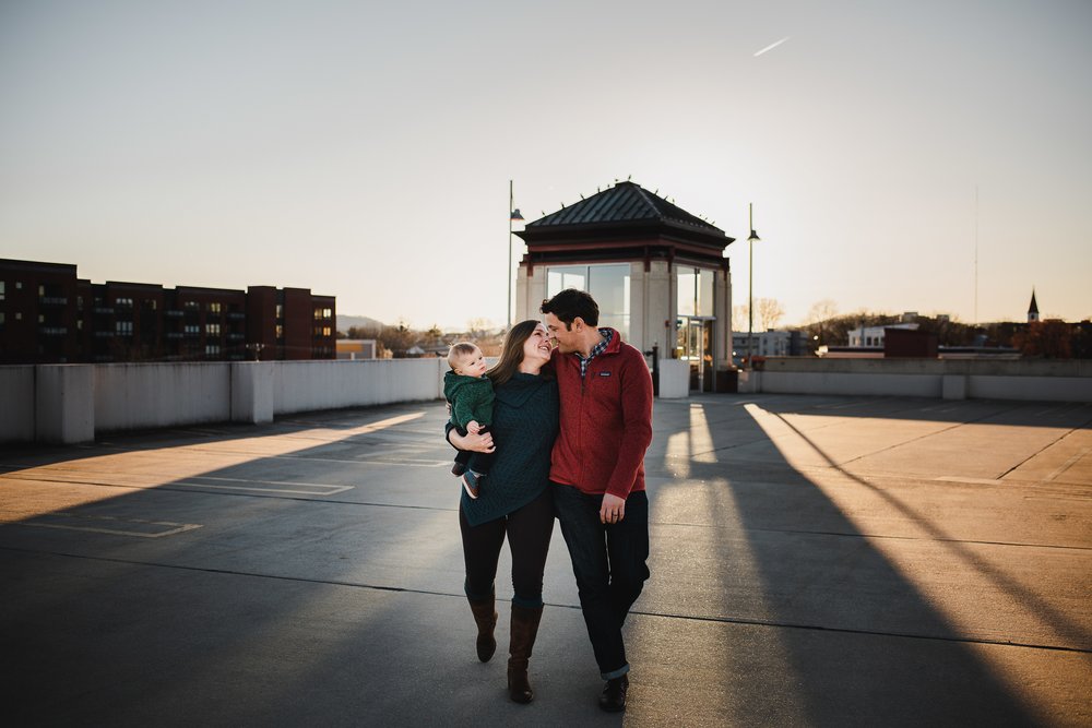 family-of-three-on-rooftop-for-family-photos-charlottesville