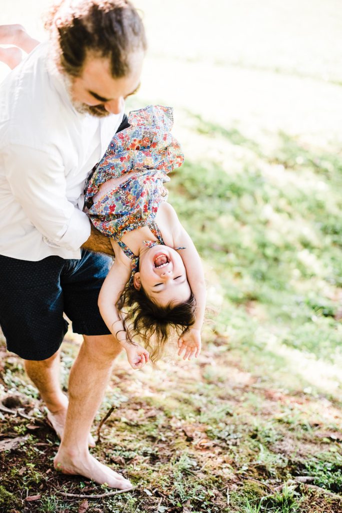 playful father and daughter pose in outdoor family session, charlottesville va