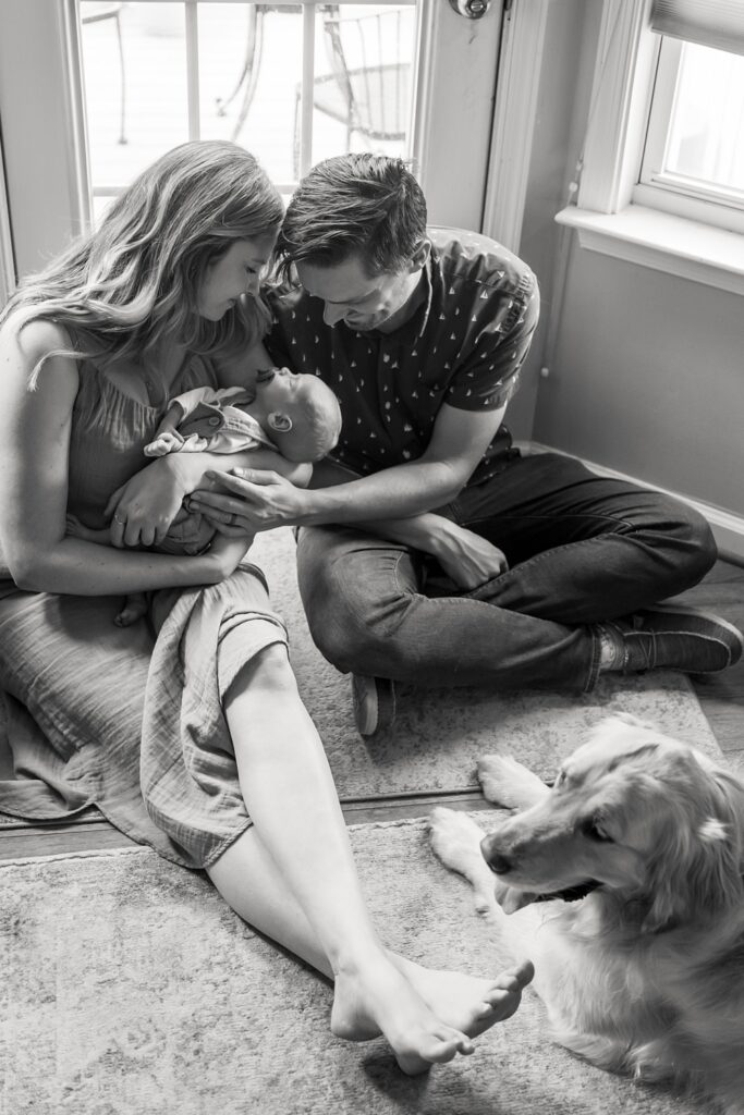 natural poses for family with newborn baby and dog
