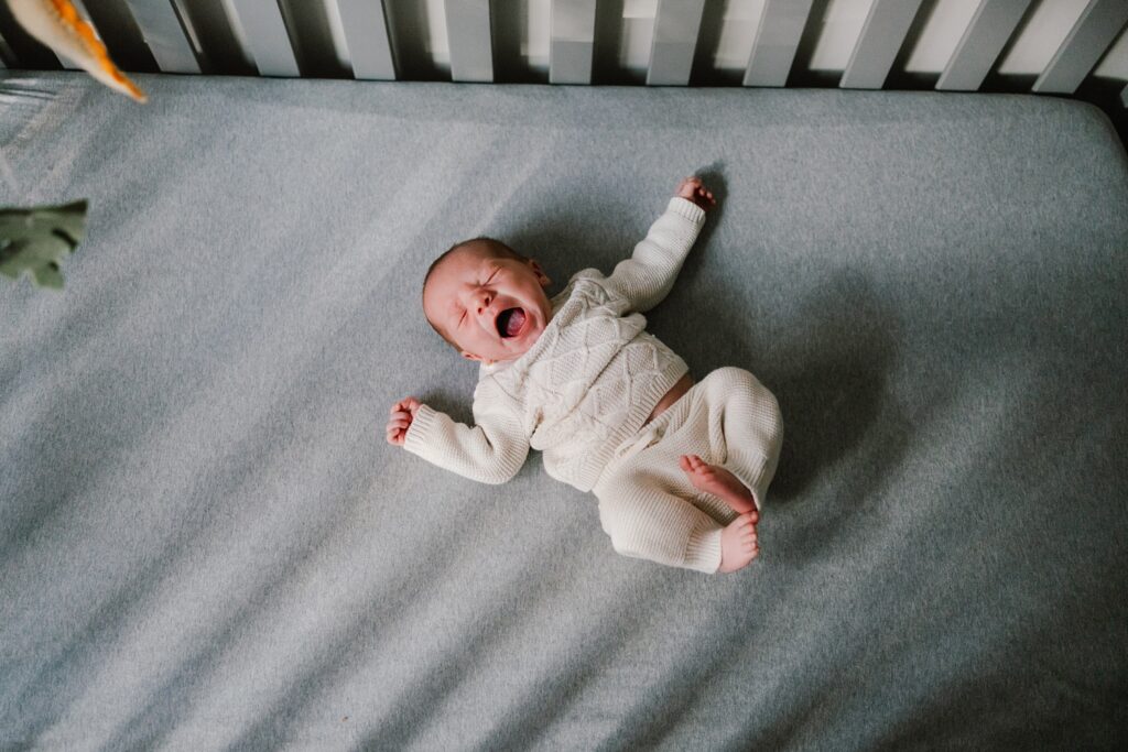 newborn in a crib, lifestyle newborn photos at home